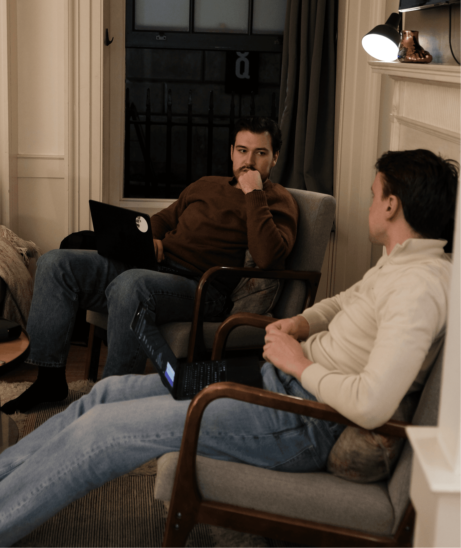 Scape teammates talking together in armchairs.
