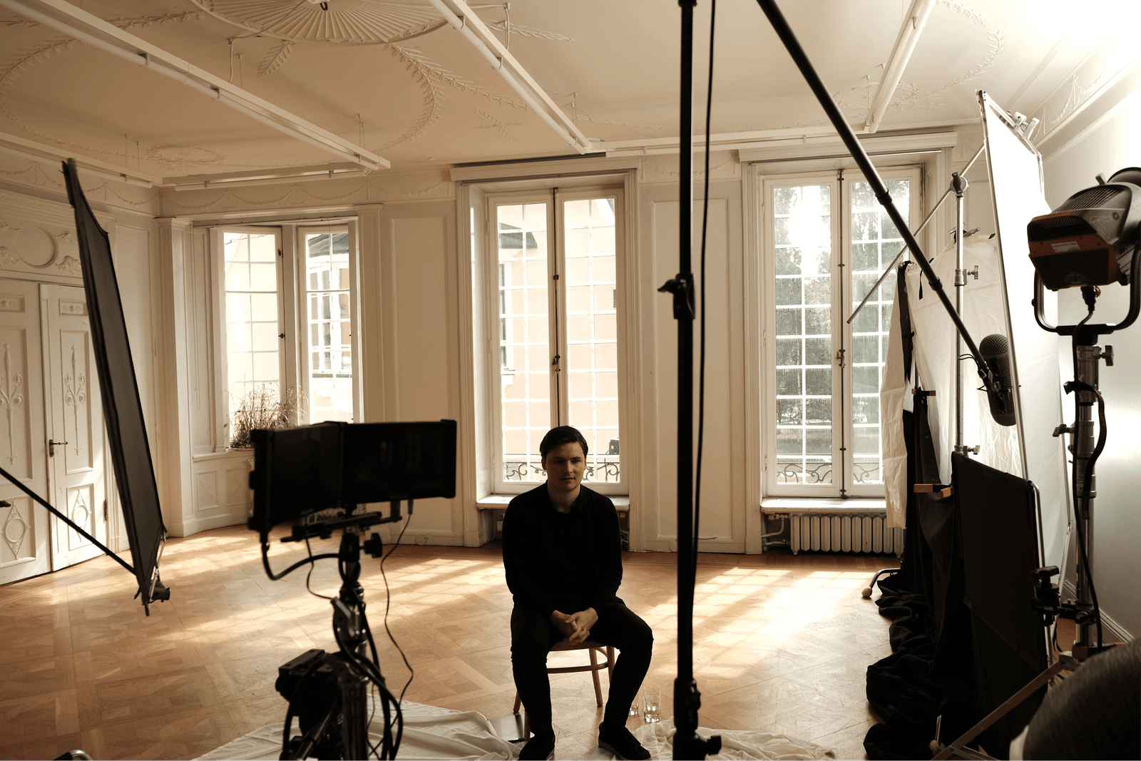 A Scape teammate seated in a studio setup.